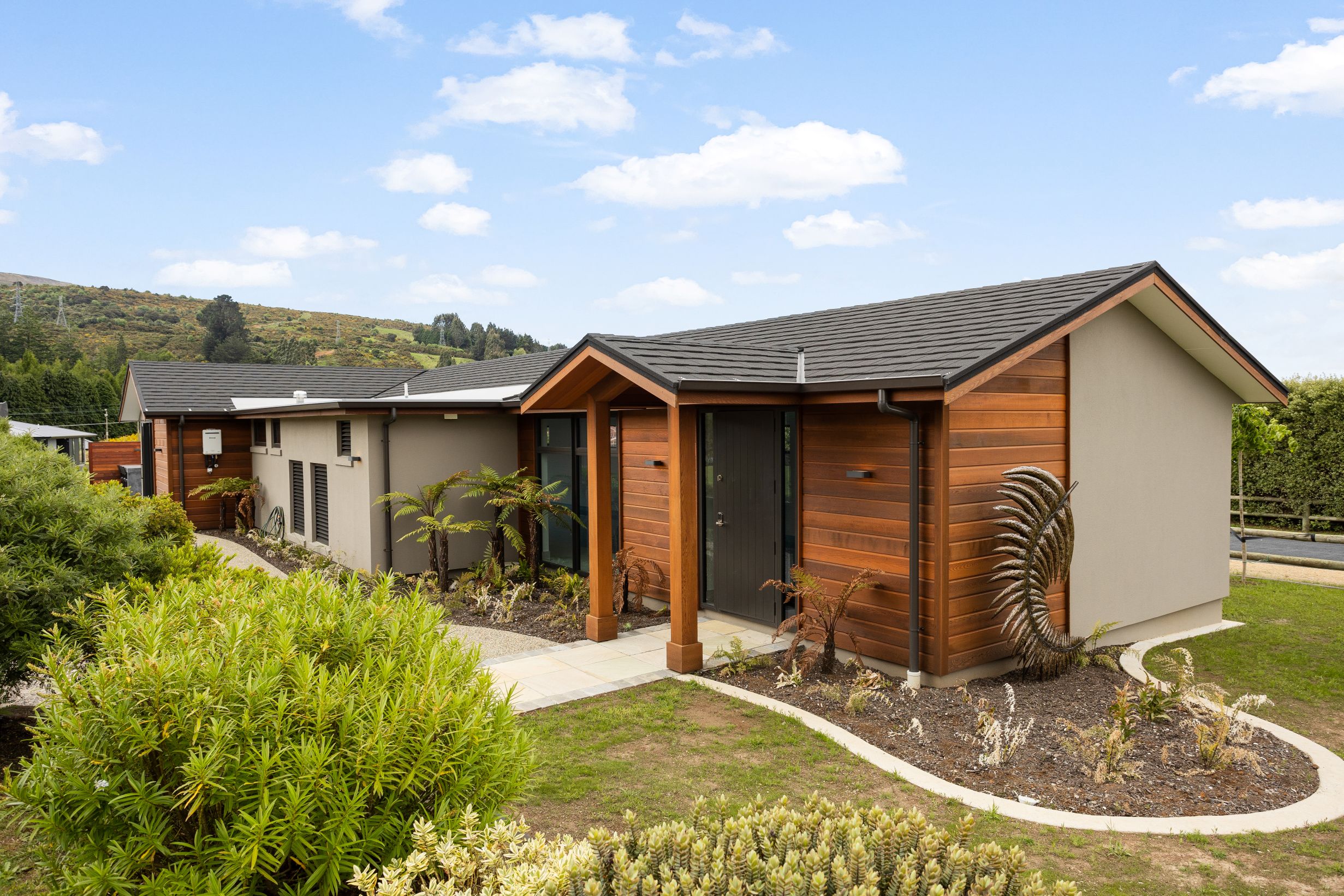 Pool-house-entry-porch-cedar-landscaping-exposed-concrete-path