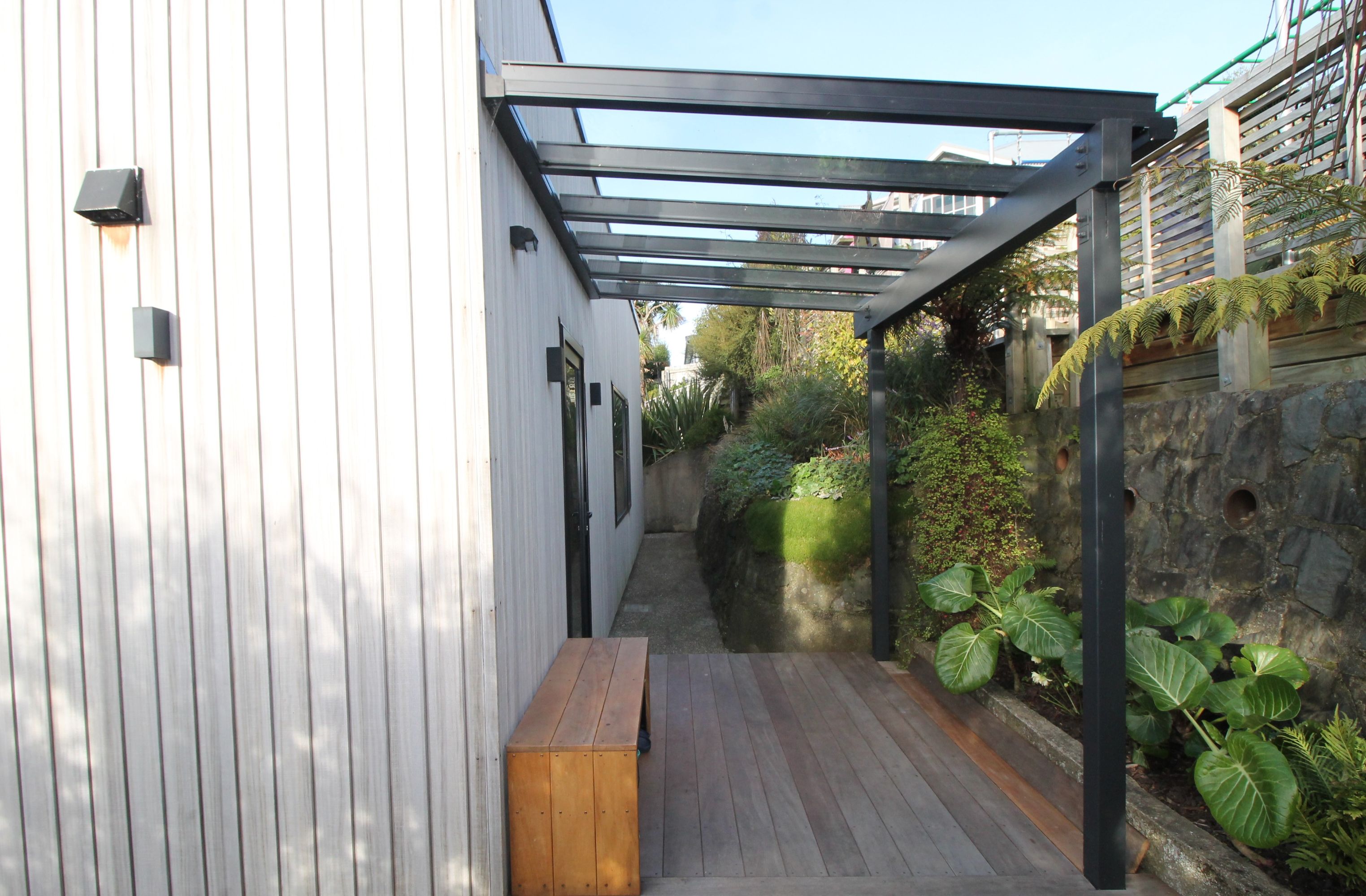 Timber-vertical-weatherboard-hardwood-kwila-deck-glass-roof-back-door-shelter