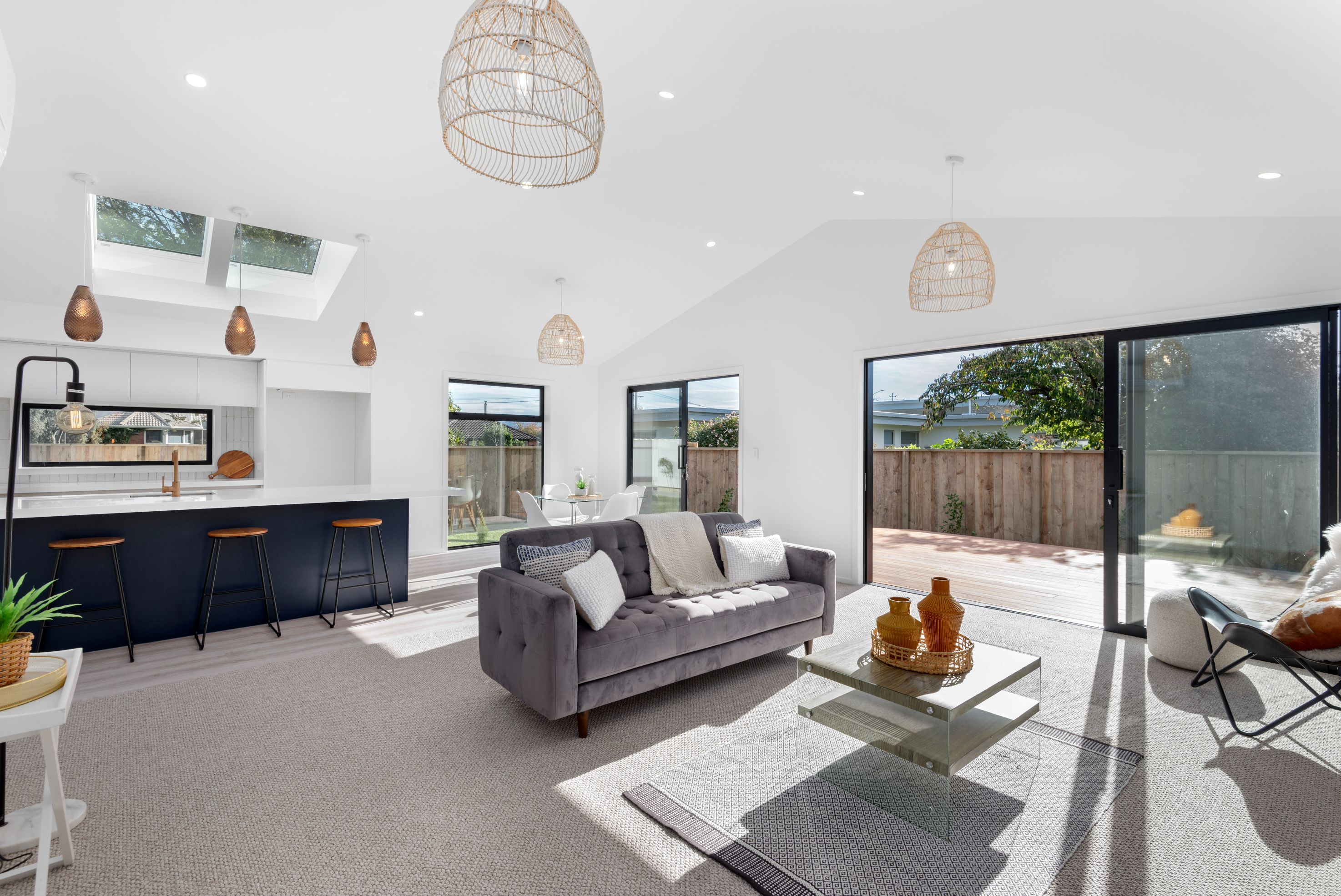 kitchen-dining-living-island-bench-skylights-indoor-outdoor-flow-deck-sliding-doors