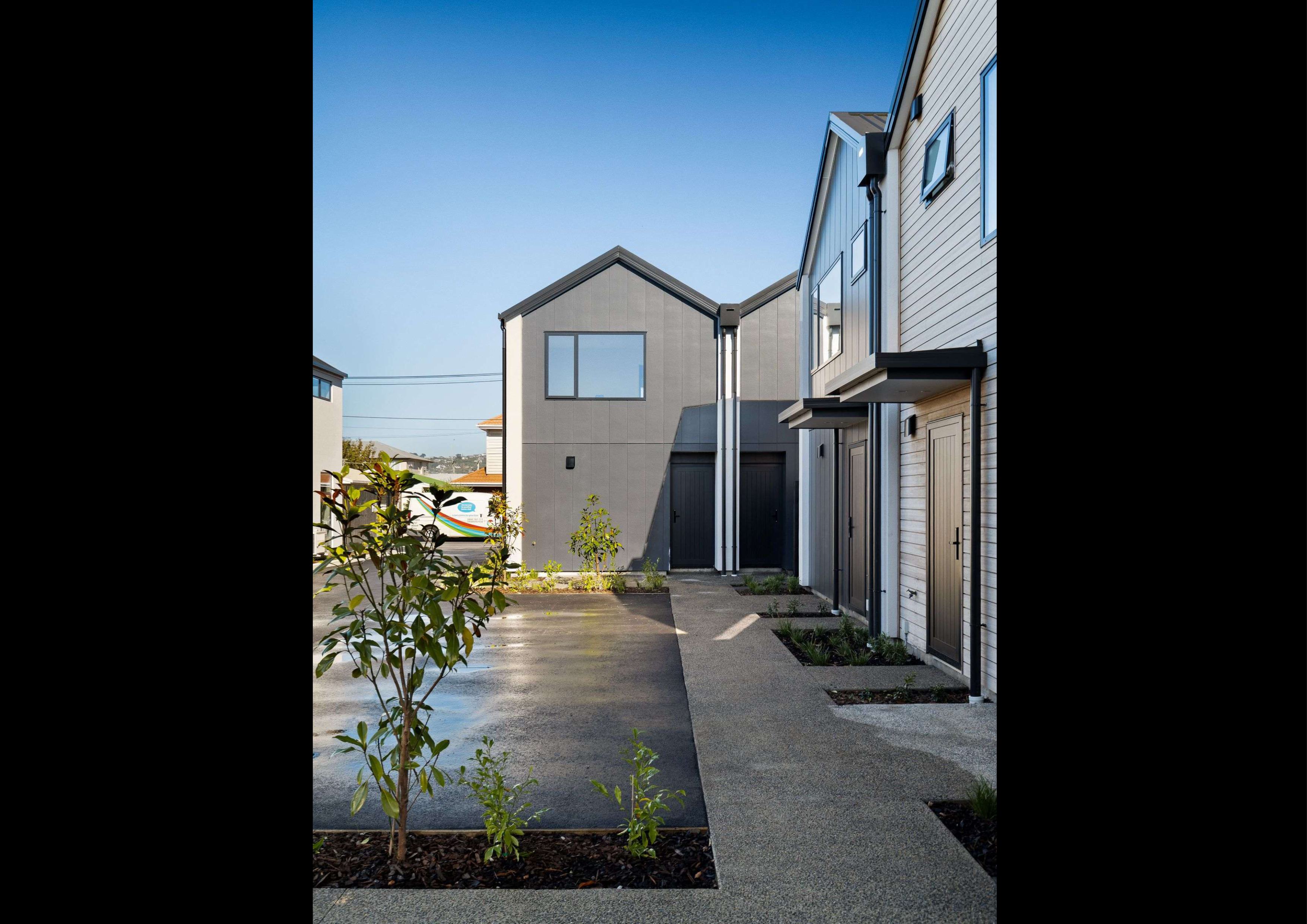 multi-uint-townhouses-Stria-cladding-Abodo-weatherboard-Sto-render-exposed-concrete-path-planting-portrait